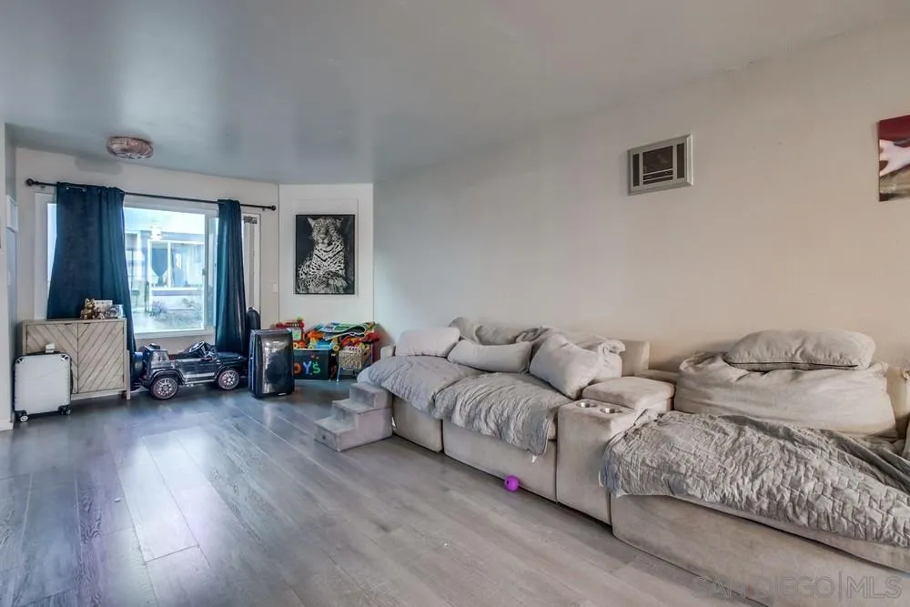 3433 Los Mochis Way Oceanside, CA 92056 - Photo 15 of 45 a living room with furniture and a wooden floor