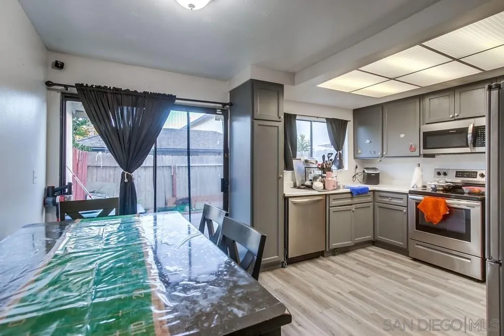 3433 Los Mochis Way Oceanside, CA 92056 - Photo 16 of 45 a kitchen with stainless steel appliances granite countertop a stove a sink dishwasher and a refrigerator