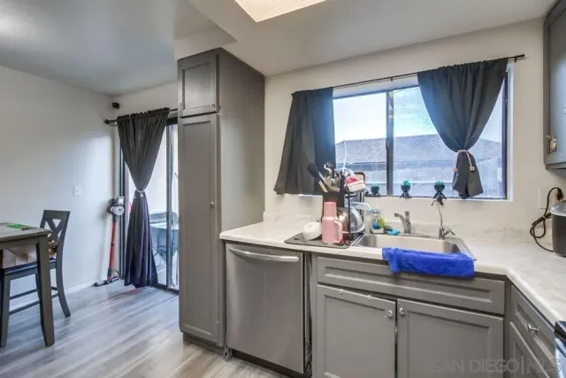 a kitchen with a sink and a refrigerator