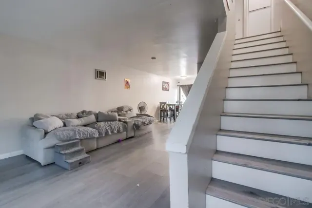 a living room with furniture and stairs