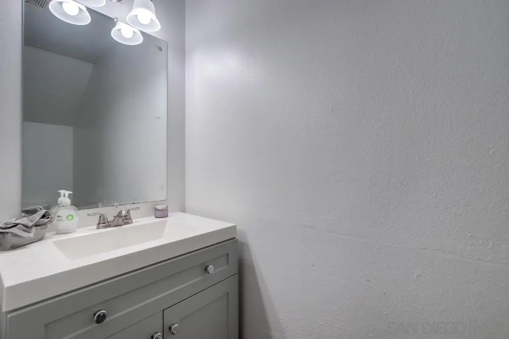 3433 Los Mochis Way Oceanside, CA 92056 - Photo 24 of 45 a bathroom with a sink vanity and a mirror