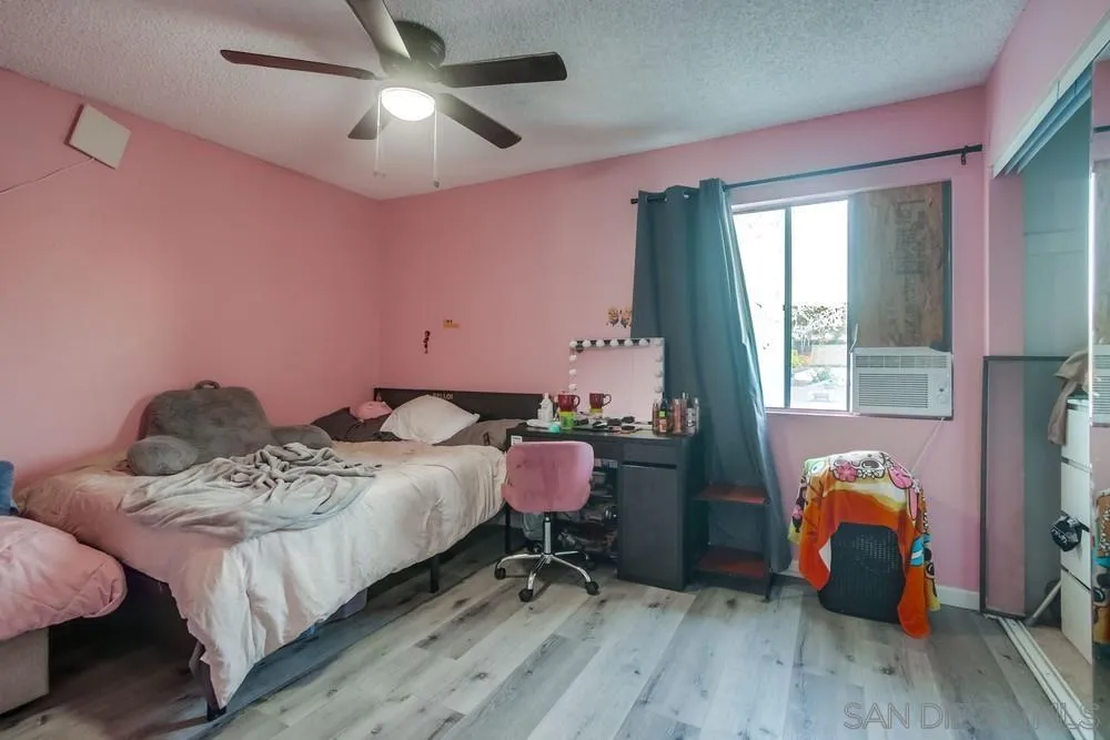 3433 Los Mochis Way Oceanside, CA 92056 - Photo 31 of 45 a bedroom with a bed and wooden floor