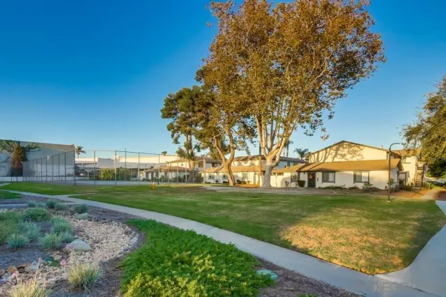 a view of a house with wooden fence