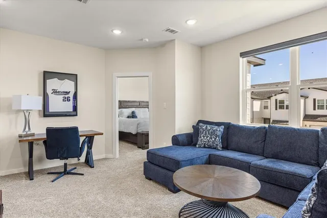 a bedroom with a bed and large window