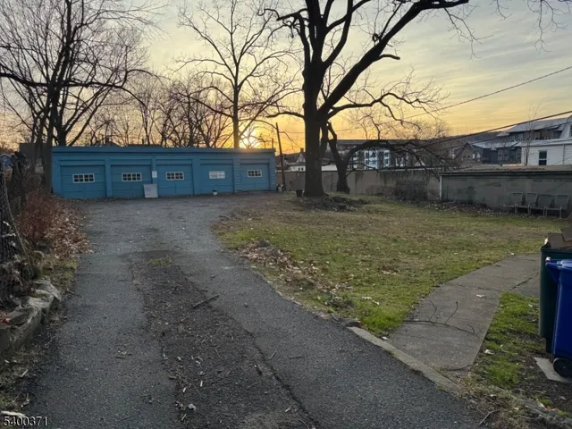 a view of backyard with large trees