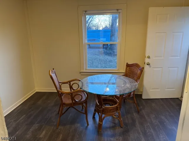 a view of a room with furniture and wooden floor