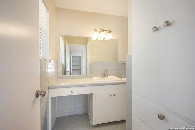 a bathroom with a sink and a mirror