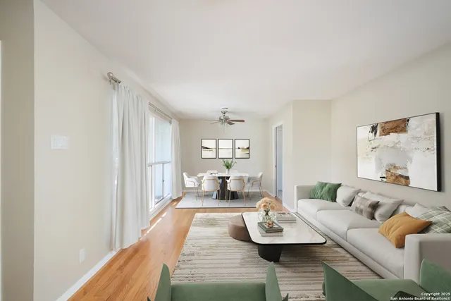 a living room with furniture and a wooden floor