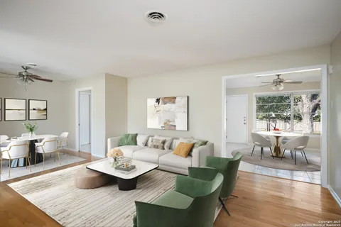 a living room with furniture and wooden floor