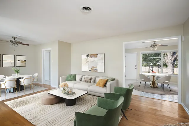 a living room with furniture and wooden floor