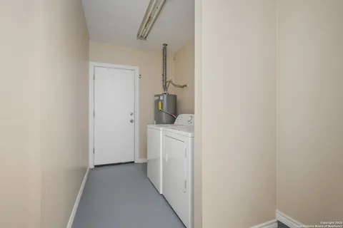 a view of a storage & utility room with a washer dryer