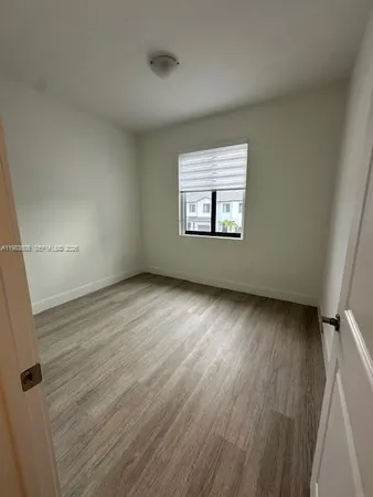 a view of a room with wooden floor