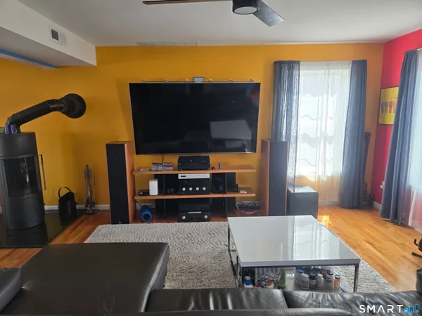a view of a bedroom with furniture and window