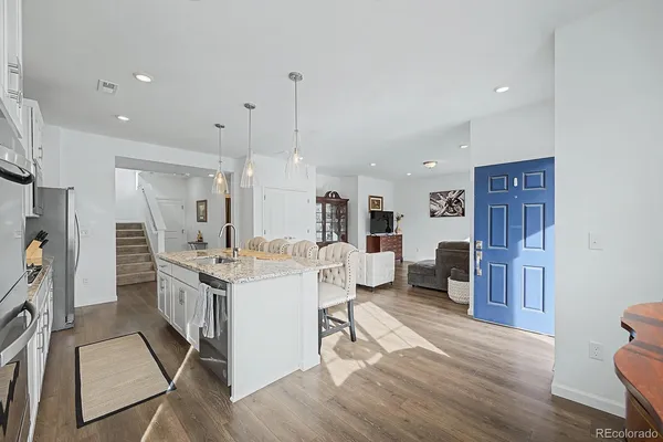 a large kitchen with a table and chairs