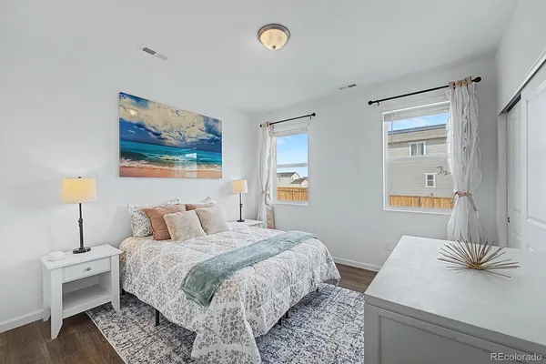 a bedroom with a bed and a couch