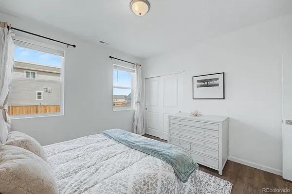 a bedroom with a bed and a dresser