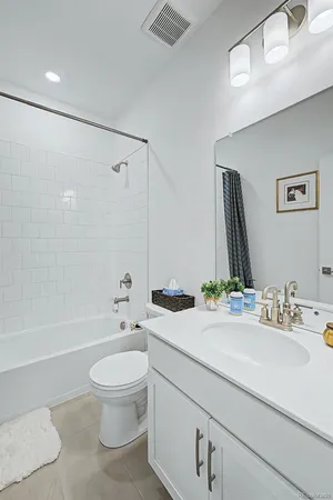 a bathroom with a sink a toilet and a large mirror