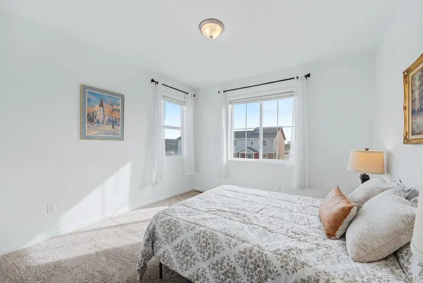 a bedroom with a large bed and a window