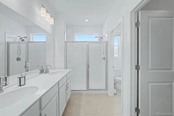 a bathroom with a double vanity sink mirror and double