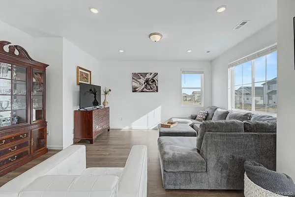 a living room with furniture a large window and a flat screen tv