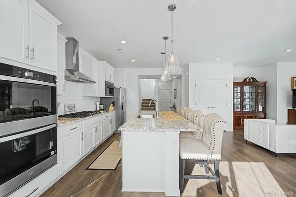 a kitchen with stainless steel appliances granite countertop a stove refrigerator sink and cabinets