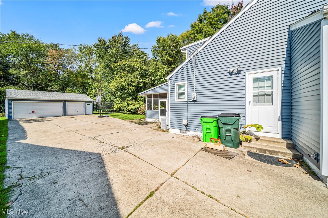 1796 Lander Road Mayfield Heights, OH 44124 - Photo 2 of 39 View of side of home with a garage and an outbuilding