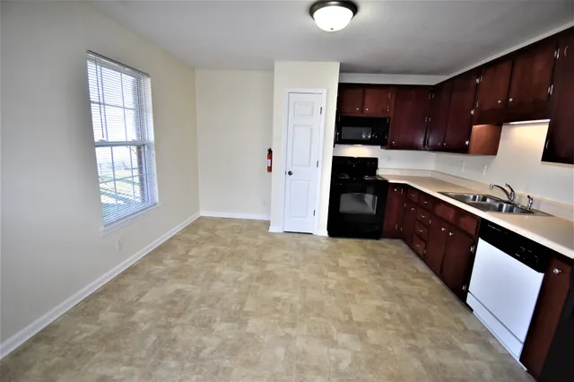 a large kitchen with cabinets and a stove