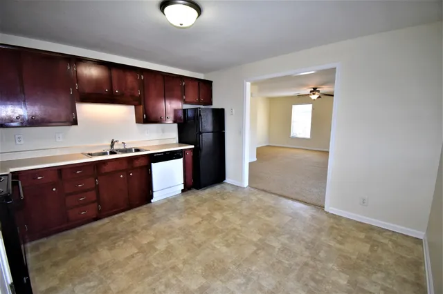 a kitchen with granite countertop stainless steel appliances and wooden cabinets
