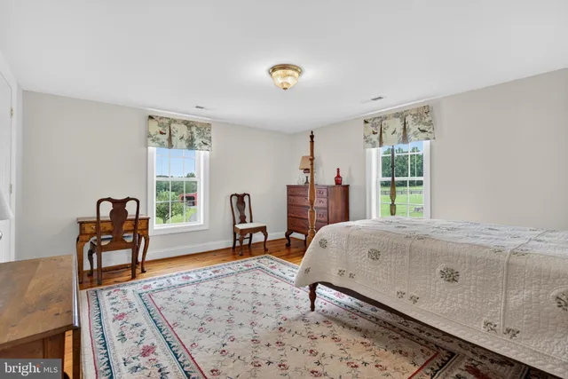 a spacious bedroom with a bed and window