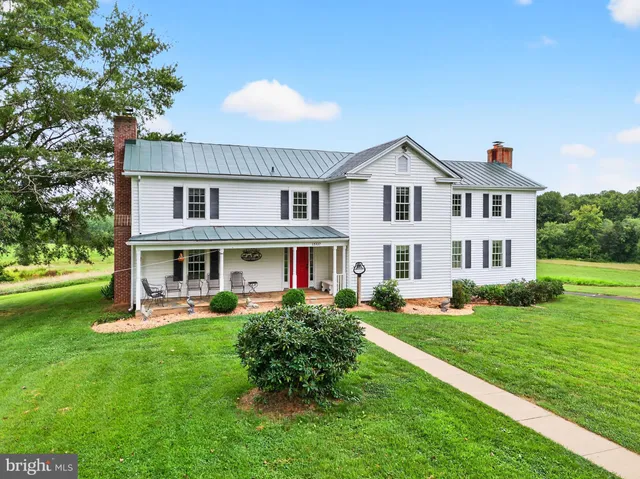 an aerial view of a house with garden space and street view