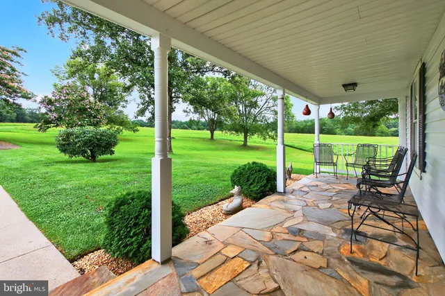 a living room with furniture a rug and a window
