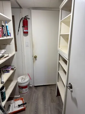 a view of a storage & utility room with empty racks