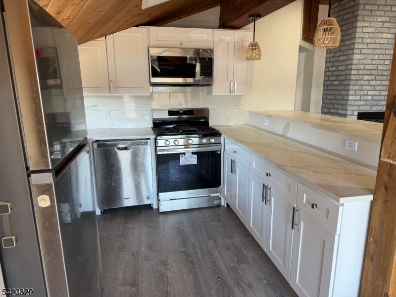 9 MacDonald Road West Milford, NJ 07421 - Photo 3 of 18 a kitchen with stainless steel appliances a stove microwave and a refrigerator
