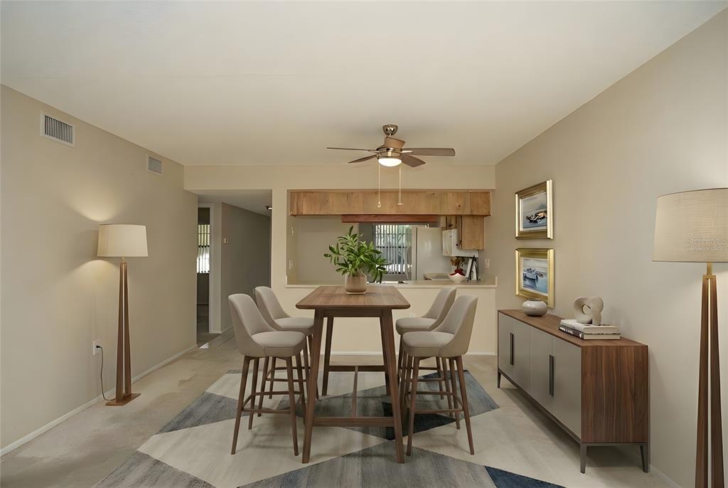 9860 62nd Avenue North, Unit 1014 St. Petersburg, FL 33708 - Photo 22 of 68 a view of a dining room with furniture and wooden floor