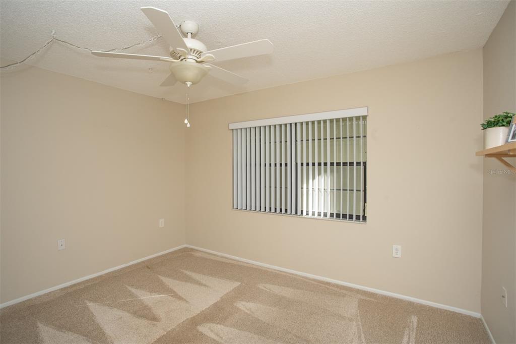 9860 62nd Avenue North, Unit 1014 St. Petersburg, FL 33708 - Photo 37 of 68 an empty room with a window and a ceiling fan