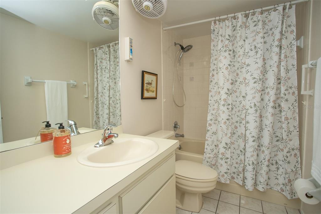9860 62nd Avenue North, Unit 1014 St. Petersburg, FL 33708 - Photo 40 of 68 a bathroom with a sink toilet and shower