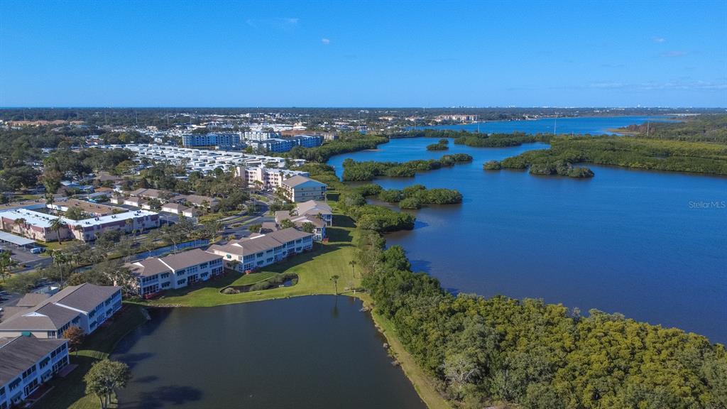 9860 62nd Avenue North, Unit 1014 St. Petersburg, FL 33708 - Photo 48 of 68 an aerial view of a houses with a lake