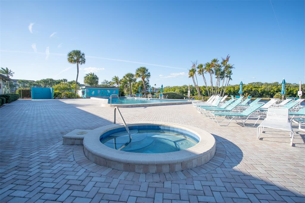 9860 62nd Avenue North, Unit 1014 St. Petersburg, FL 33708 - Photo 54 of 68 a view of a swimming pool with a yard