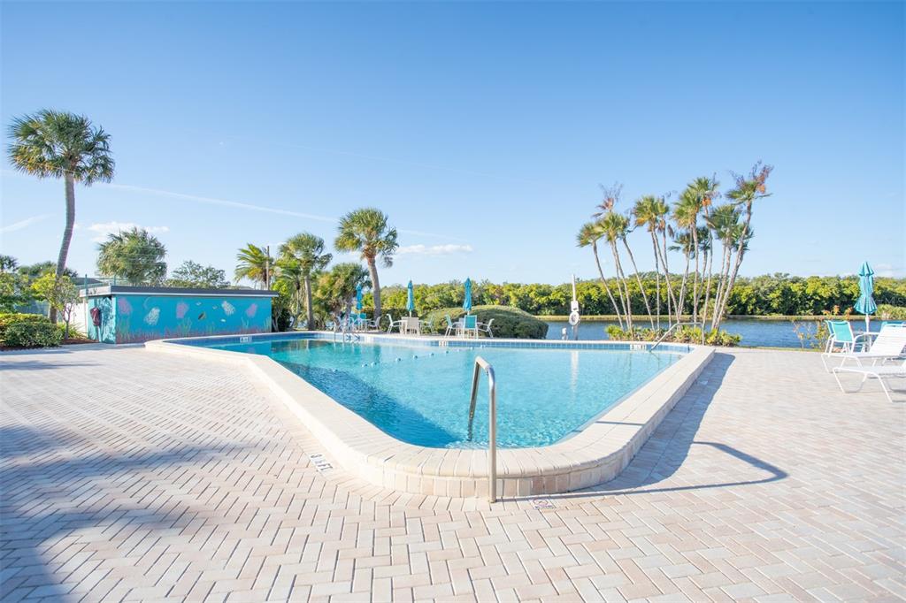 9860 62nd Avenue North, Unit 1014 St. Petersburg, FL 33708 - Photo 55 of 68 a view of a swimming pool with a lounge chair