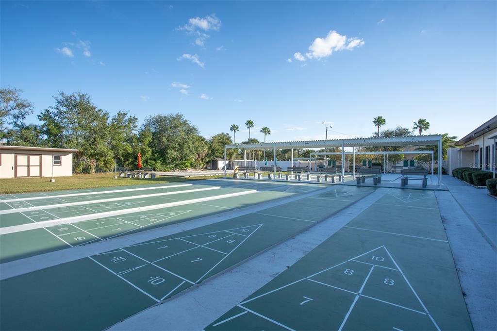 9860 62nd Avenue North, Unit 1014 St. Petersburg, FL 33708 - Photo 58 of 68 a view of a tennis ground with large trees
