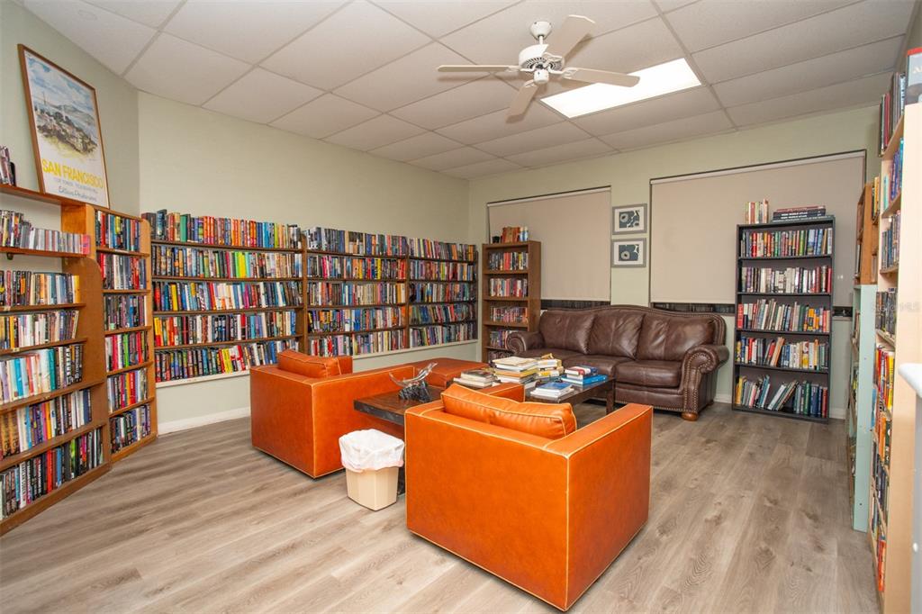 9860 62nd Avenue North, Unit 1014 St. Petersburg, FL 33708 - Photo 67 of 68 a living room with furniture and a book shelf