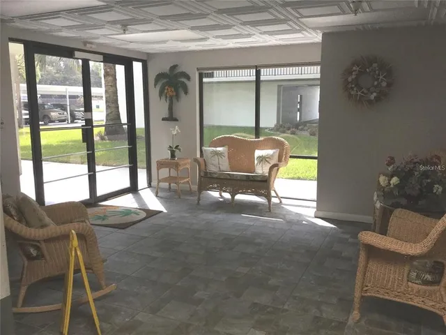 an empty room with a window and a ceiling fan