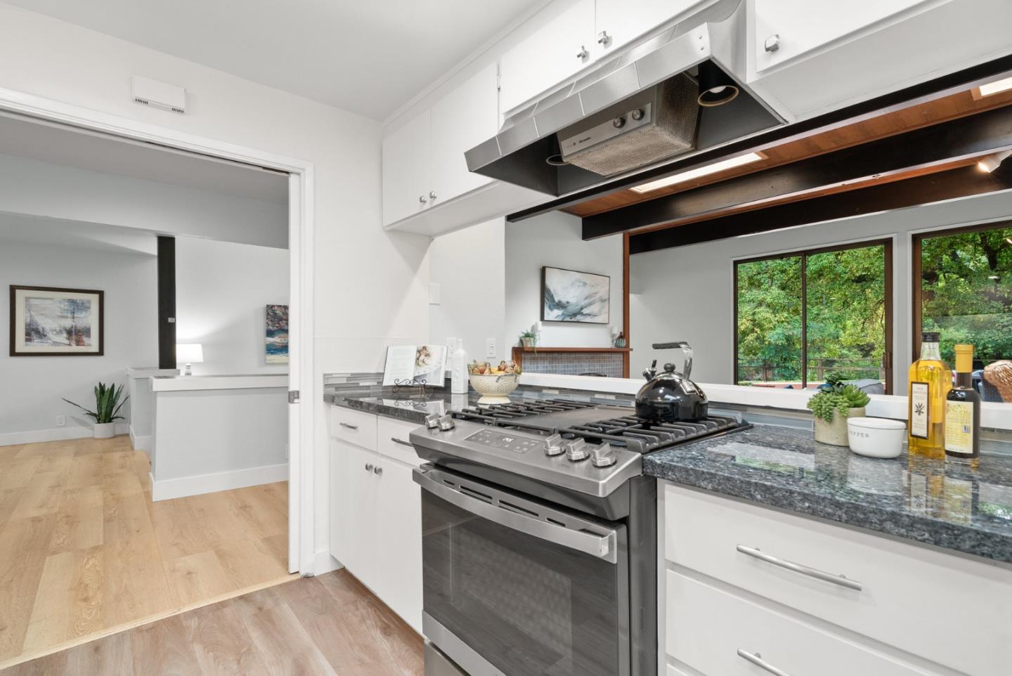 382 Riverside Avenue Ben Lomond, CA 95005 - Photo 12 of 85 a kitchen with stainless steel appliances granite countertop a stove a sink and a granite counter tops with white cabinets