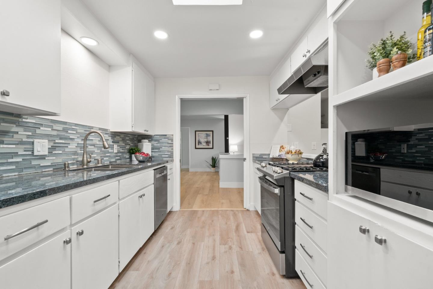 382 Riverside Avenue Ben Lomond, CA 95005 - Photo 14 of 85 a large kitchen with granite countertop a stove top oven a sink a counter space and cabinets