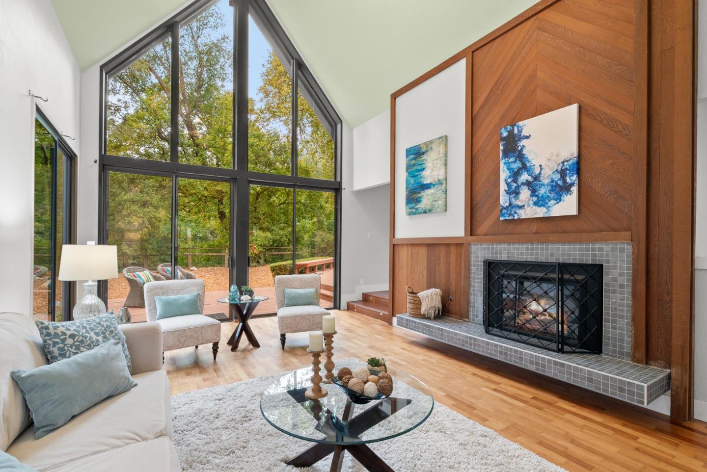382 Riverside Avenue Ben Lomond, CA 95005 - Photo 6 of 85 a living room with furniture a fireplace and floor to ceiling windows