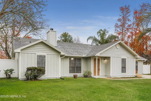 a front view of a house with a garden and yard