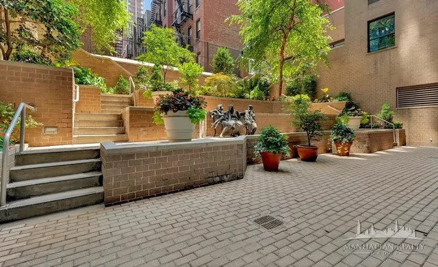 a view of a patio with table and chairs and potted plants