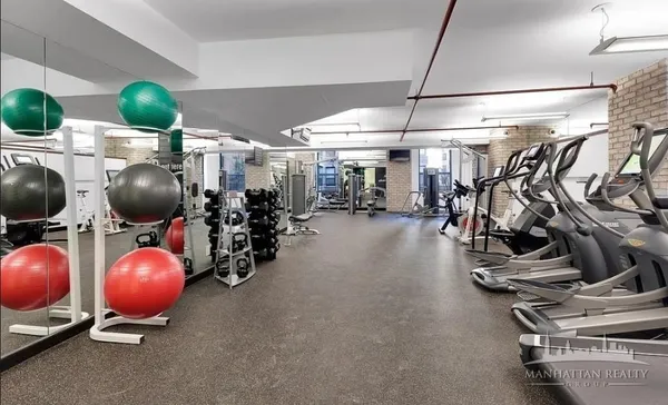 a room with gym equipment and windows
