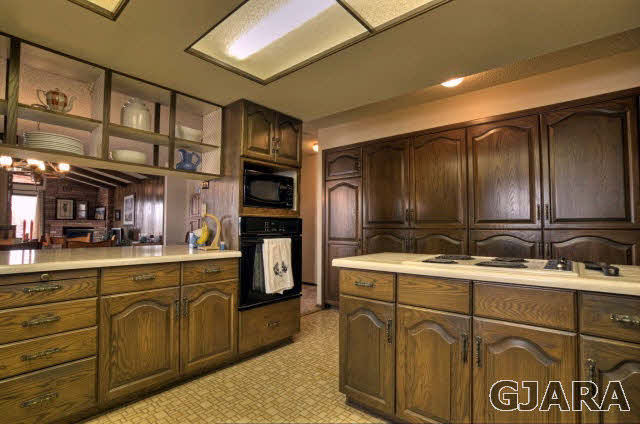 1363 21 Road Fruita, CO 81521 - Photo 3 of 9 a kitchen with kitchen island granite countertop a sink cabinets and stainless steel appliances
