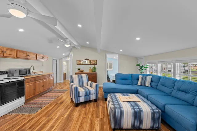 a living room with furniture and a wooden floor